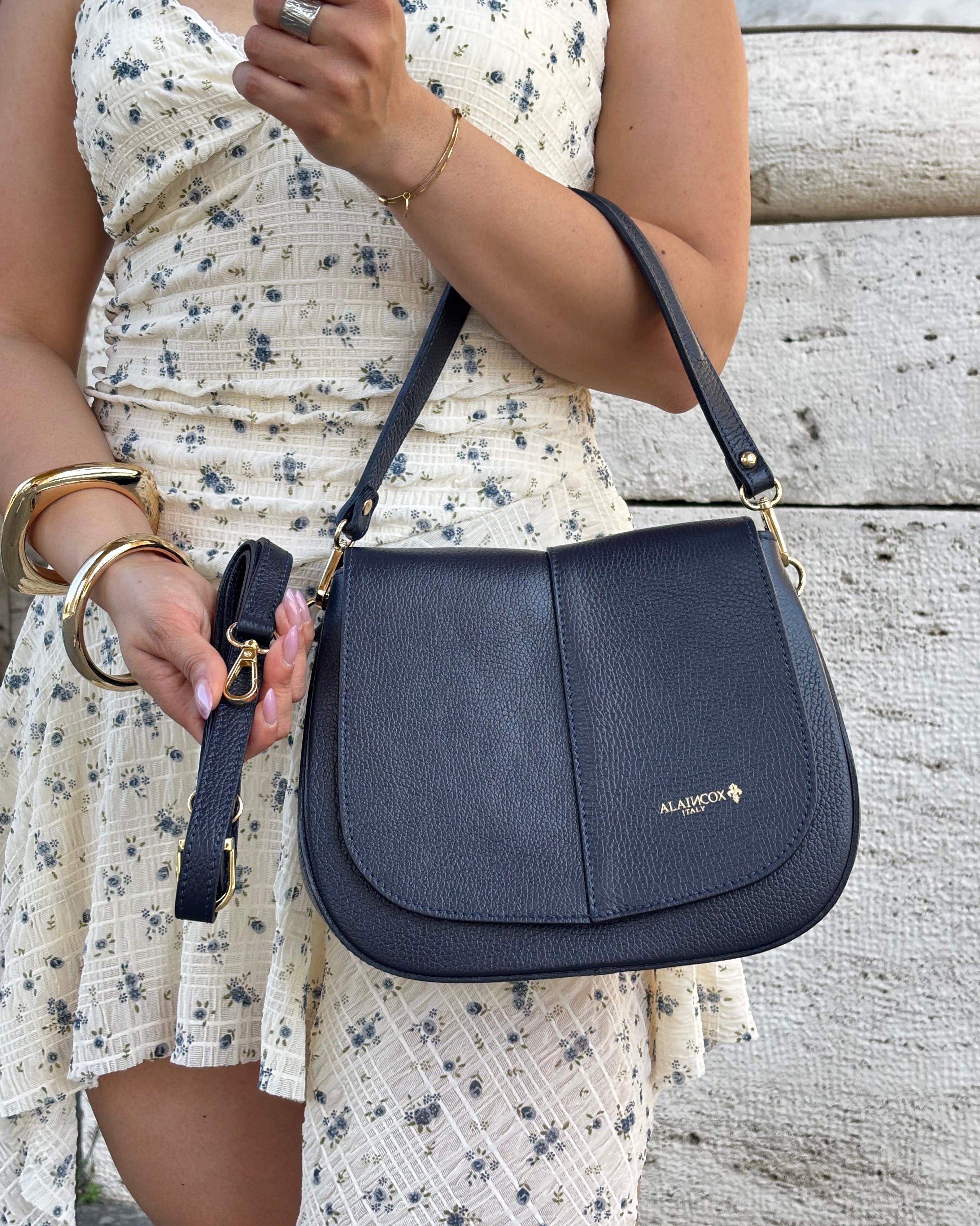 Borsa ALICIA in vera pelle martellata Made in Italy firmata ALAINCOX. Elegante, capiente e versatile, con dettagli dorati, tracolla regolabile e chiusura MAGNETICA. Scopri la qualità artigianale italiana nella boutique ALAINCOX Genova Via di Fossatello. Perfetta per un look chic e quotidiano.