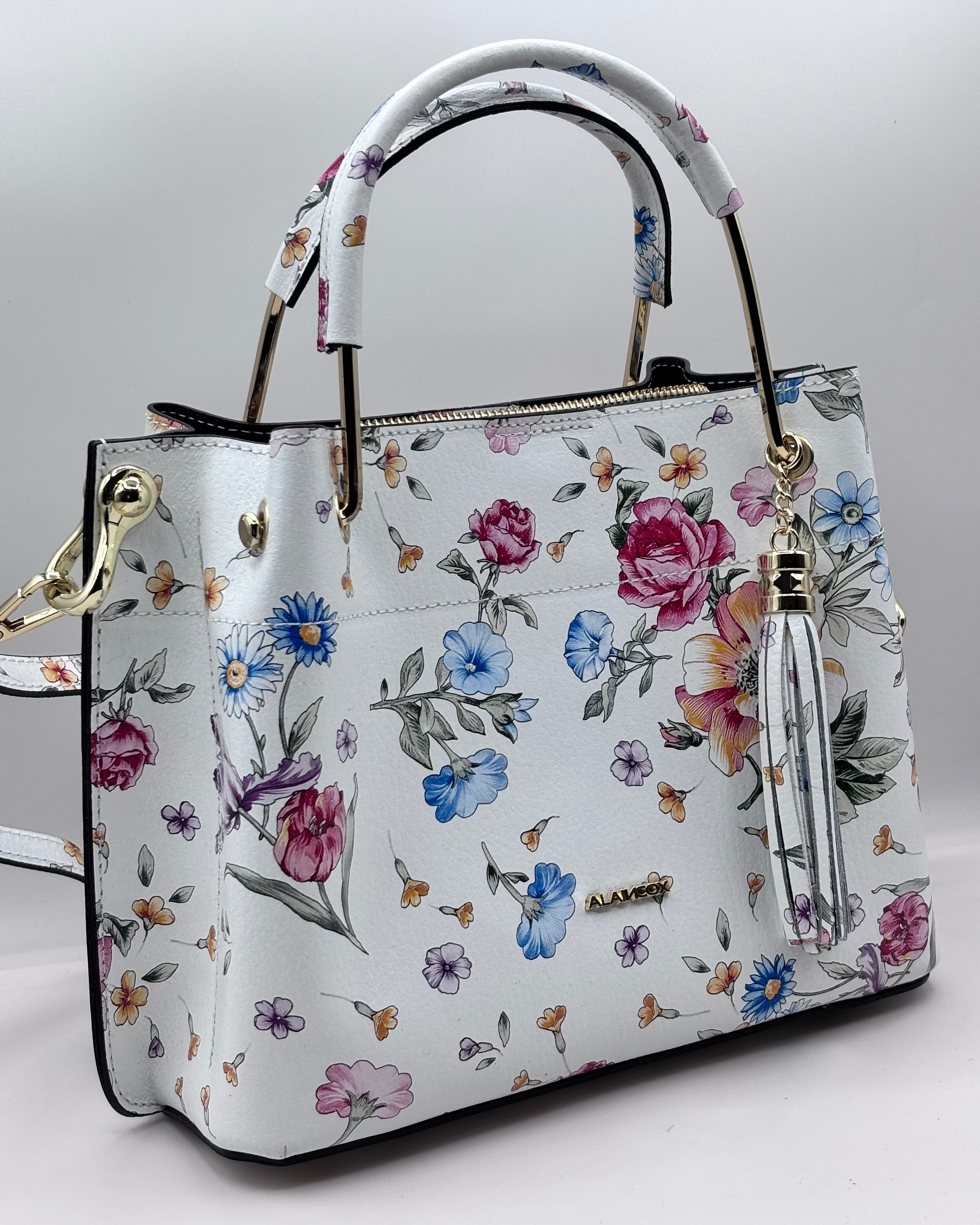 Borsa PAULETTE SPRING da donna in vera pelle martellata made in italy, colore bianco floreale, firmata Alaincox, negozio di Genova, con pochette interna con zip, tracolla regolabile e dettagli in acciaio dorato, elegante e capiente per uso quotidiano.