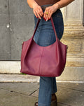 Borsa LOLA in vera pelle martellata, capiente ed elegante, con dettagli in acciaio inox dorato. Dotata di chiusura con zip, interno foderato con tasca interna e tracolla regolabile in vera pelle, è perfetta per un look raffinato e pratico ogni giorno. ALAINCOX Genova Via di fossatello 
